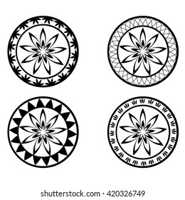 Set of four black and white round ornaments