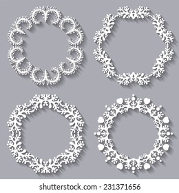 Set of four circular carved varied frames on grey background with long shadows for your design. Lacy and delicate ornament.