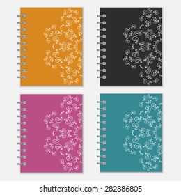 Set of four colorful notebook covers with flower design. Orange, black, purple and blue pocket books with ornate pattern
