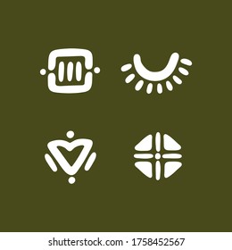 Conjunto de cuatro símbolos étnicos. Colección vectorial de señales planas estilizadas. Resumen de elementos geométricos aislados en el fondo verde.