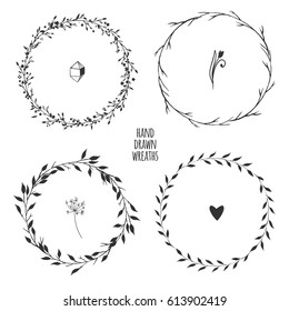 Set of four hand drawn floral wreaths for spring design isolated on white. Vector illustration.
