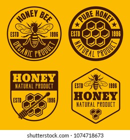 Set of four honey and beekeeping badges, emblems, labels vector illustration on yellow background