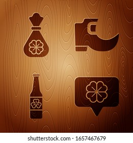 Set Four leaf clover in speech bubble, Money bag with four leaf clover, Beer bottle with four leaf clover and Tradition leprechaun boots on wooden background. Vector