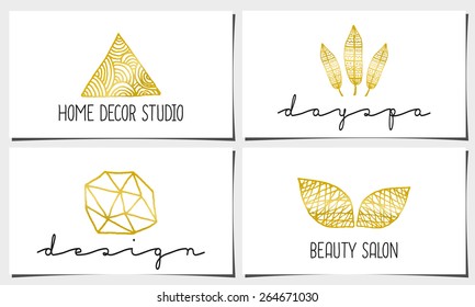  A set of four modern and elegant business card templates in white, gold and black. Hand drawn golden design elements, feathers, leaves, triangle, geometric shapes.