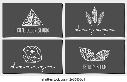 A set of four modern and elegant business card templates in chalkboard style. Hand drawn design elements, feathers, leaves, triangle, geometric shapes.