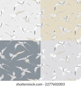 Set of four seamless patterns with flying white-tailed tropicbirds. Vector illustration.