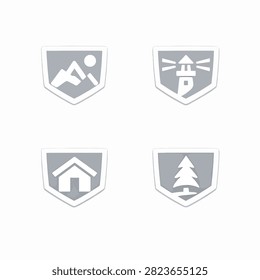 Set of four shield emblems featuring mountain hiking lighthouse home and pine tree icons