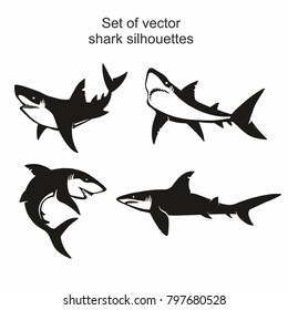 Set of four vector shark silhouettes isolated on white background, symbols, icon, design elements.  shark symbols, design elements