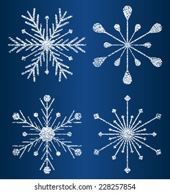 set of four vector textured snowflakes on blue background