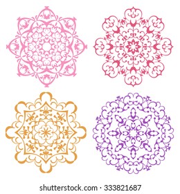 Set of four warm color lacy eastern round ornaments mandalas isolated over white