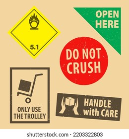 Set Of Fragile Sticker Do Not Crush And Case Icon Packaging Symbols Sign, Open Here And Handle With Case Rubber Stamp On Cardboard Background. Use On Package.