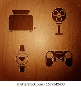 Set Gamepad , Toaster with toasts , Smart watch showing heart beat rate  and Electric fan  on wooden background. Vector