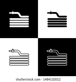 Set Garden hose or fire hose icon isolated on black and white background. Spray gun icon. Watering equipment.  Vector Illustration