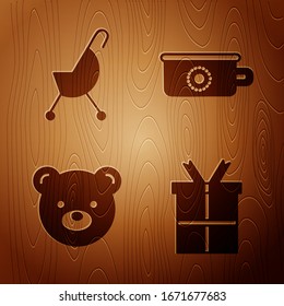Ponga la caja de regalo, el coche de bebé, el juguete de peluche de oso de Teddy y la caca de bebé sobre fondo de madera. Vector