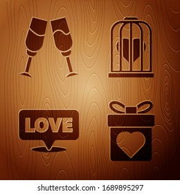 Set Gift box with heart, Glass of champagne, Speech bubble with text love and Heart in the bird cage on wooden background. Vector