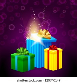 set of gift boxes with beautiful light coming from them