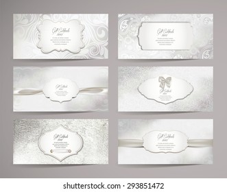 Set of  gift certificates with floral design elements and white ribbons