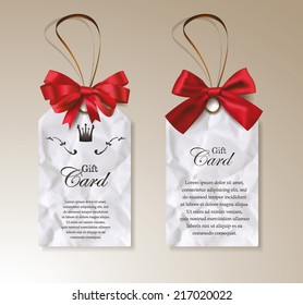 Set of gift tag-shaped cards with red bows