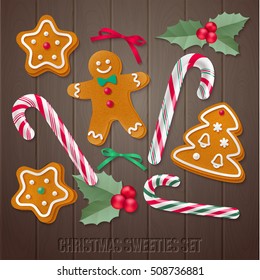 Set of gingerbread Christmas cookies with holly and candy canes. Vector holiday elements for your design on dark wooden background.