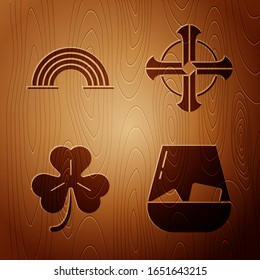 Set Glass of whiskey, Rainbow, Four leaf clover and Celtic cross on wooden background. Vector