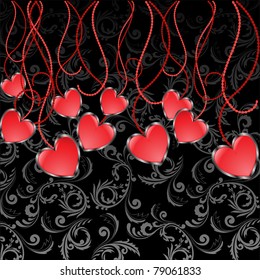 set of glossy red hearts hanging on sinuous thread