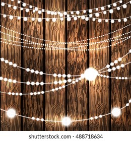 Set Of Glowing White String Christmas Lights For Xmas Holiday Greeting Cards Decoration On Wooden Background. Vector 