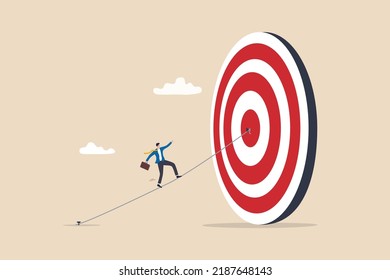 Set goal and take action to achieve goal or target, aiming or motivation to grow business and success, effort or skill to reach goal concept, businessman walking on the line aiming at target bullseye.