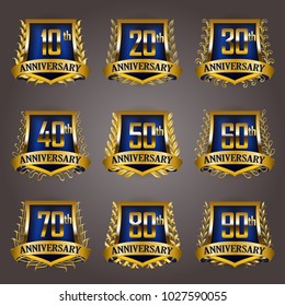 Set of gold anniversary badges with laurel wreaths, shield, numbers. Decorative emblem of jubilee on gray background. Filigree element, frame, border, icon, logo for web, page design in vintage style