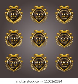 Set of gold anniversary badges with laurel wreaths, shield, numbers. Decorative emblem of jubilee on gray background. Filigree element, frame, border, icon, logo for web, page design in vintage style