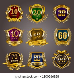 Set of gold anniversary badges with laurel wreaths, shield, numbers. Decorative emblem of jubilee on gray background. Filigree element, frame, border, icon, logo for web, page design in vintage style