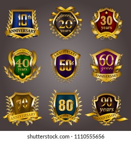 Set of gold anniversary badges with laurel wreaths, shield, numbers. Decorative emblem of jubilee on gray background. Filigree element, frame, border, icon, logo for web, page design in vintage style