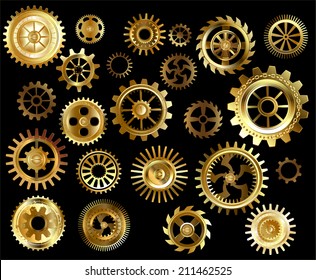 Set of gold and brass gears on a black background.