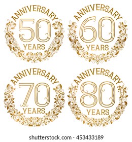 Set of golden anniversary emblems. Fiftieth, sixtieth, seventieth, eightieth years signs in vintage style.