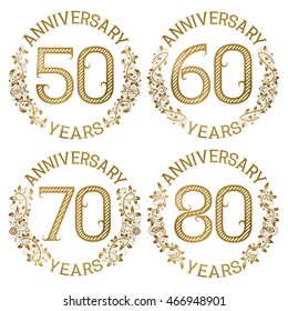Set of golden anniversary emblems. Fiftieth, sixtieth, seventieth, eightieth years signs in vintage style.