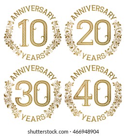 Set of golden anniversary emblems. Tenth, twentieth, thirtieth, fortieth years signs in vintage style.