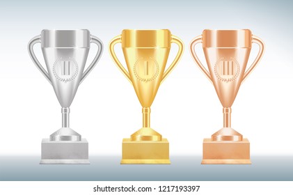 Set of golden, bronze and silver Trophy cups or goblets isolated on white background. Realistic Vector illustration
