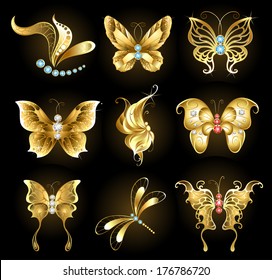 Set of golden dragonflies and butterflies, encrusted with sapphires, rubies and diamonds on black background.