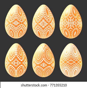 Set of golden eggs with white decorated patterns. Collection of easter symbols isolated on black.