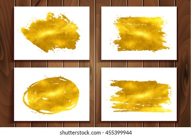 Set of golden glitter spots with halftone effect. Golden sparkling brush strokes isolated on white background.