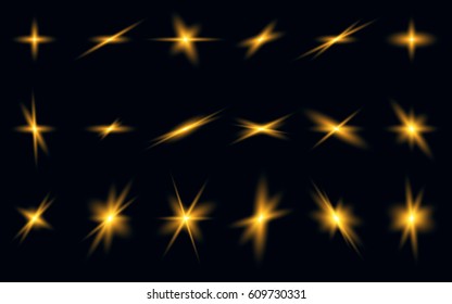 A set of golden glowing flashes on a dark background. Bright explosion