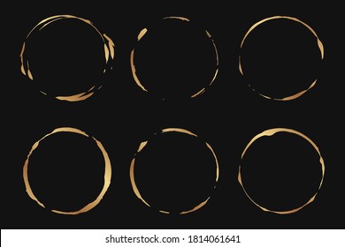 Set of golden grunge circles on a black background.