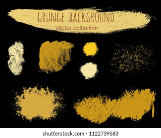 Set of golden ink vector stains. Grunge brush collection isolated on black