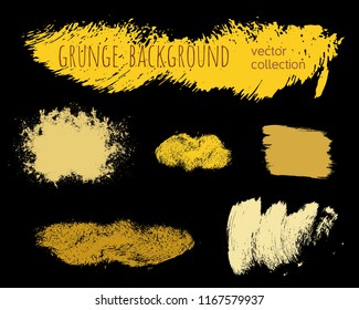 Set of golden ink vector stains. Grunge brush collection isolated on black