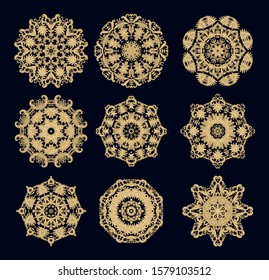 Set of golden  laced  vector decorative rosettes mandalas, snowflakes  on dark  background