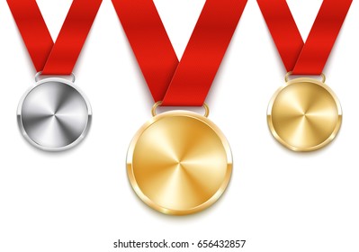 Set of golden, silver and bronze medals with red ribbons.