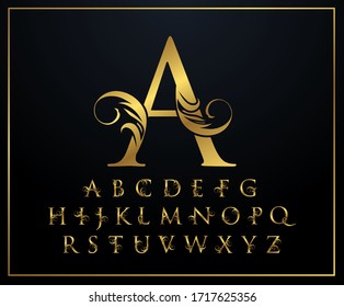 Set of Golden swirl alphabet font uppercase letters with flowers leaves and gold splatters isolated on black background. 