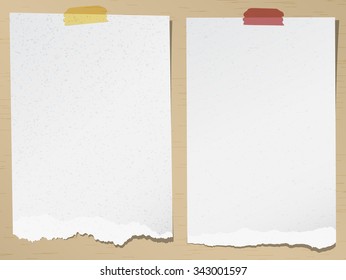 Set of gray torn grainy note papers with adhesive tape on brown background