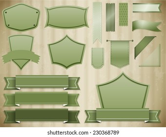 Set of green labels and ribbon on cardboard background