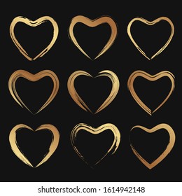 Set of grunde paintbrush golden hearts for wedding or valentine's day greeting cards or decoration.