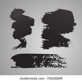 Set of grunge black vector painted brush strokes isolated on gray background.